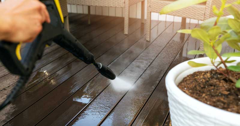 Using a pressure washer to remove green mold from a deck
